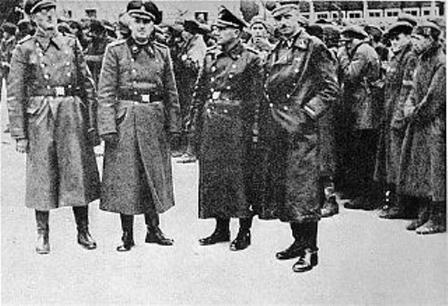 SS officers posing in front of a newly arrived transport of Soviet prisoners of war -Mauthausen